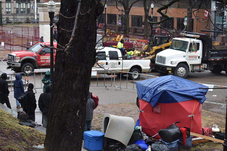 City crews erect fencing and remove a tent from the Grand Parade on Monday, Mar. 11, 2024. The HRM says it has "de-designated" the tent encampment site.