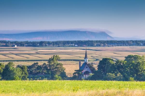 At Grand Pré, vast fields on the valley floor give way to the North Mountain and Blomidon beyond.