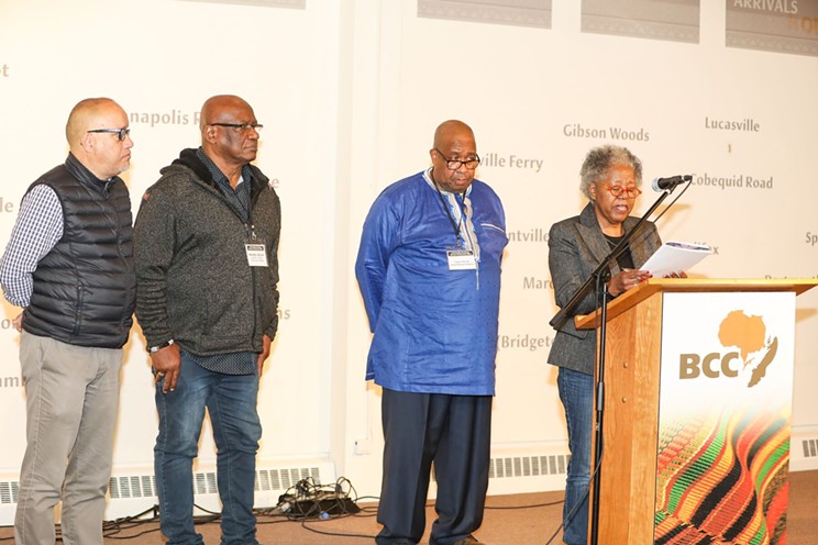 Isaac Saney, Michael Heslop, Cikiah Thomas and Sylvia Hamilton deliver a letter of resolution at the USS conference's final session.